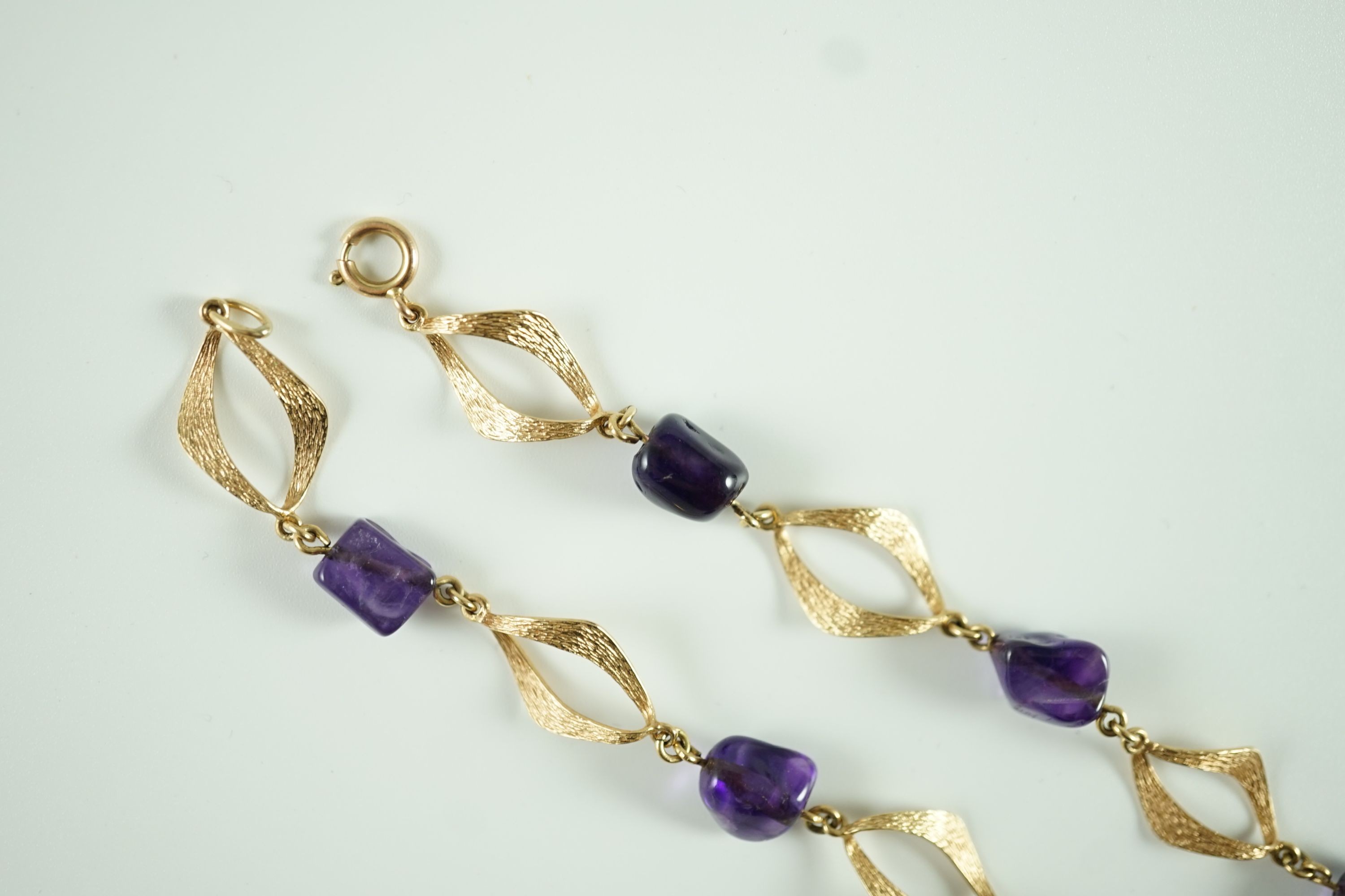 A modern textured 14ct gold and amethyst pebble set necklace and a pair of similar earrings
